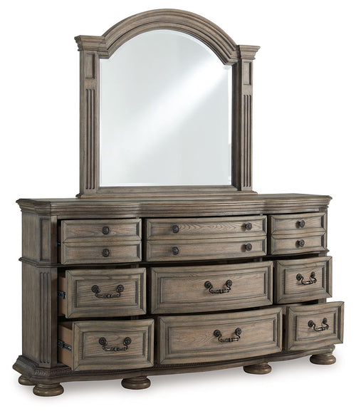 Light brown dresser with arched mirror, six center drawers and side cabinet drawers