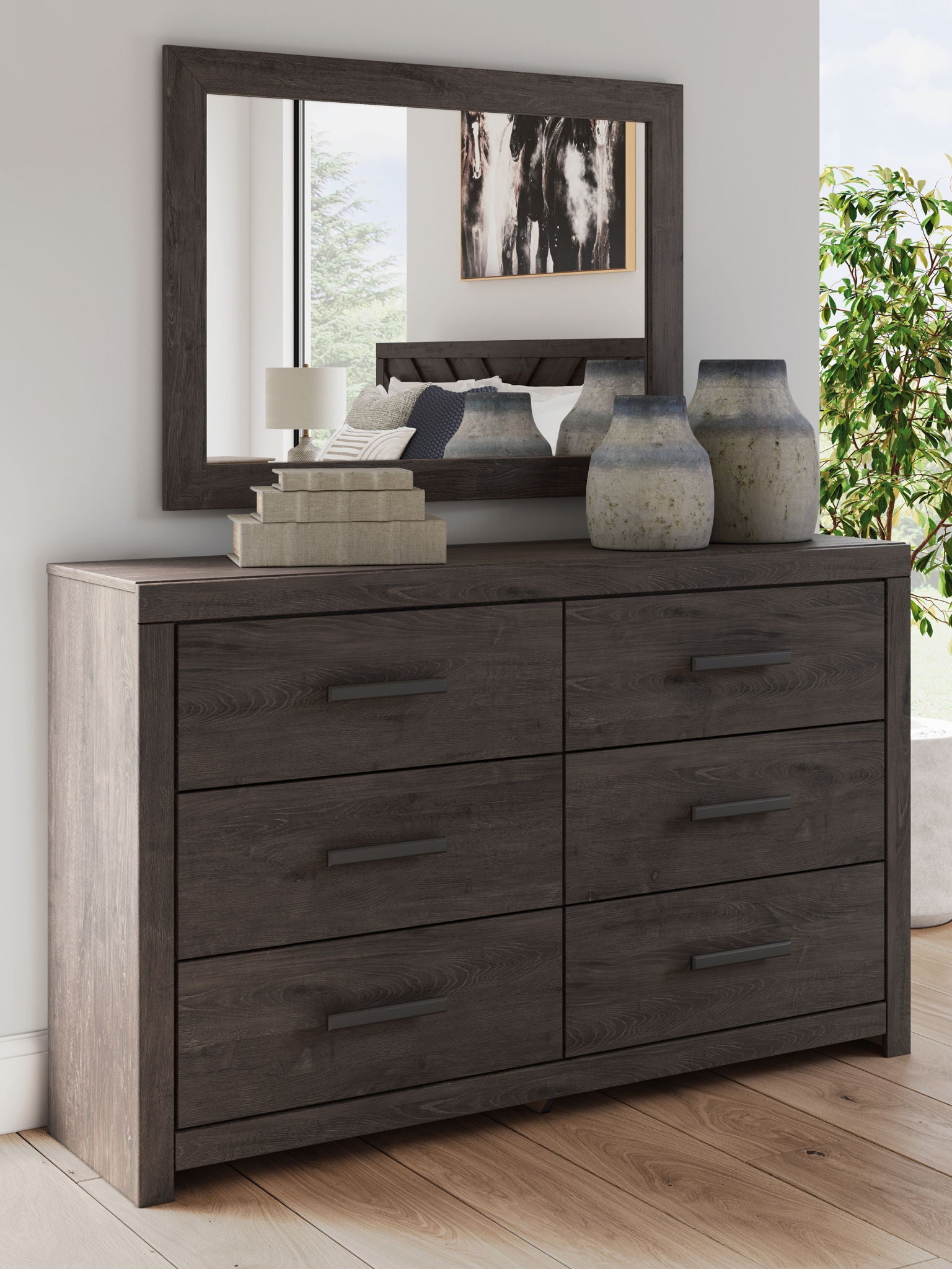 Dark gray dresser with mirror above and six drawer fronts