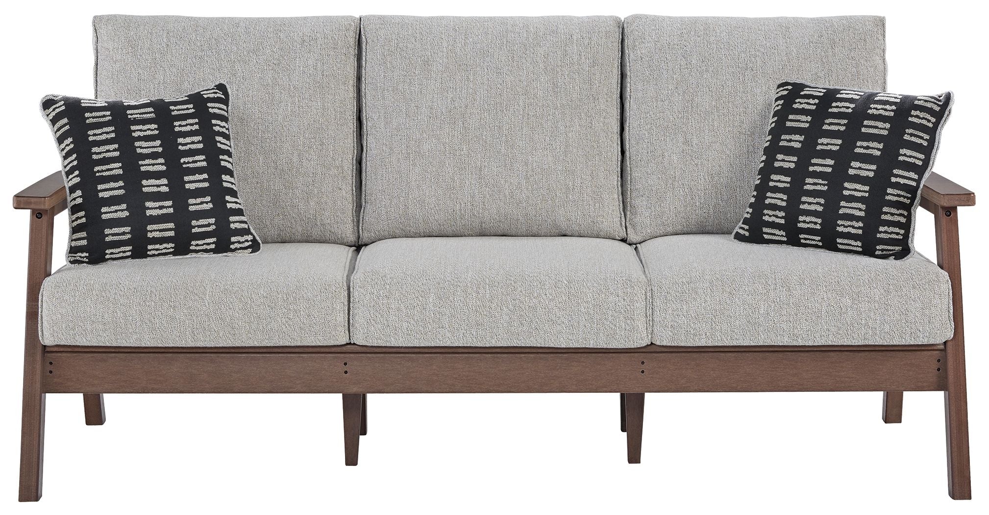 Grey upholstered sofa with three seat cushions and two black-and-white throw pillows