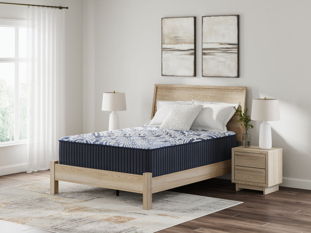 Blue upholstered mattress with navy side panels and blue patterned top