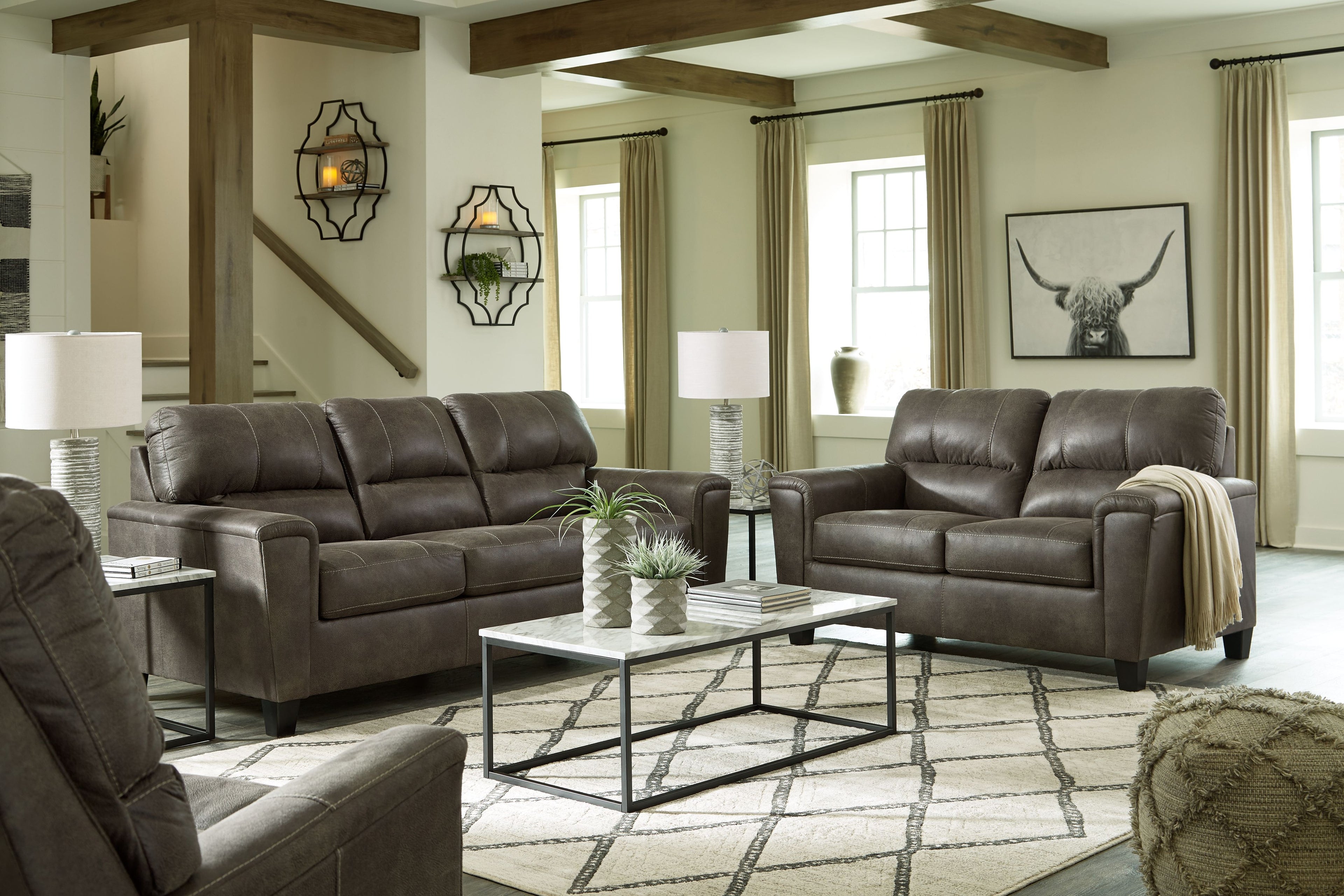 Dark gray loveseat and sofa with padded arms and tufted back cushions