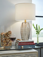 Glass table lamp with white drum shade and geometric gray faceted base