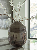 Harpwick dark glass vase with floral stems in a room setting