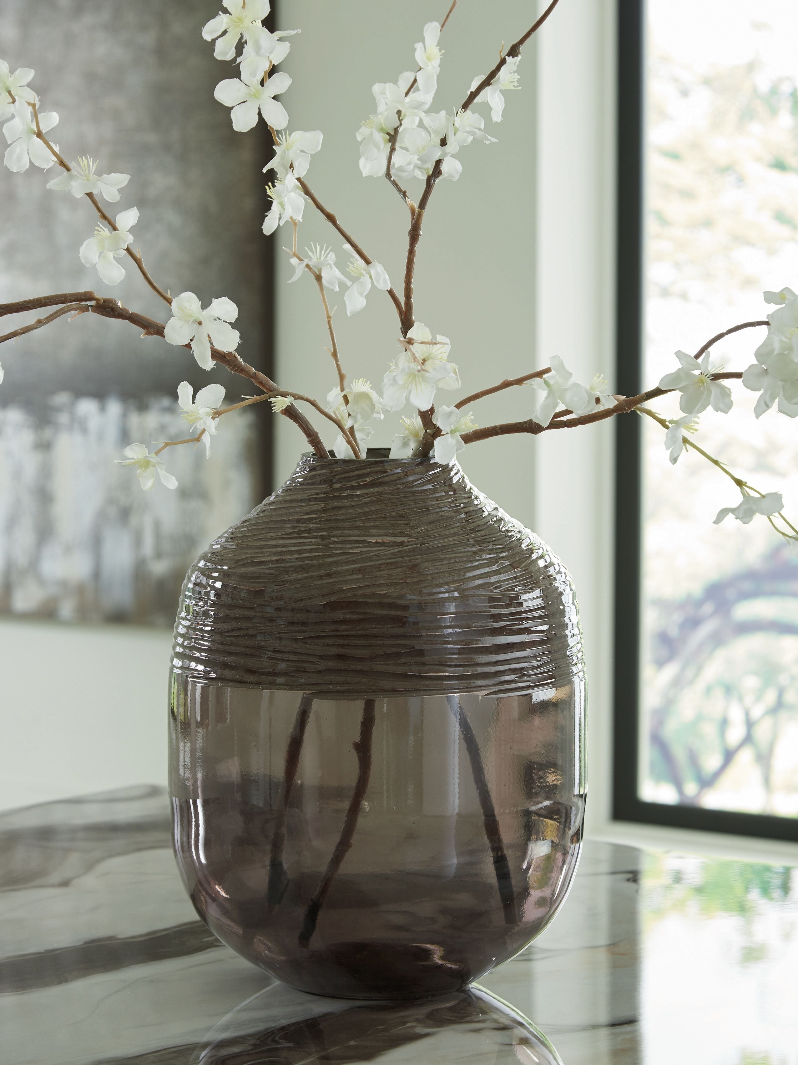 Harpwick dark glass vase with floral stems in a room setting