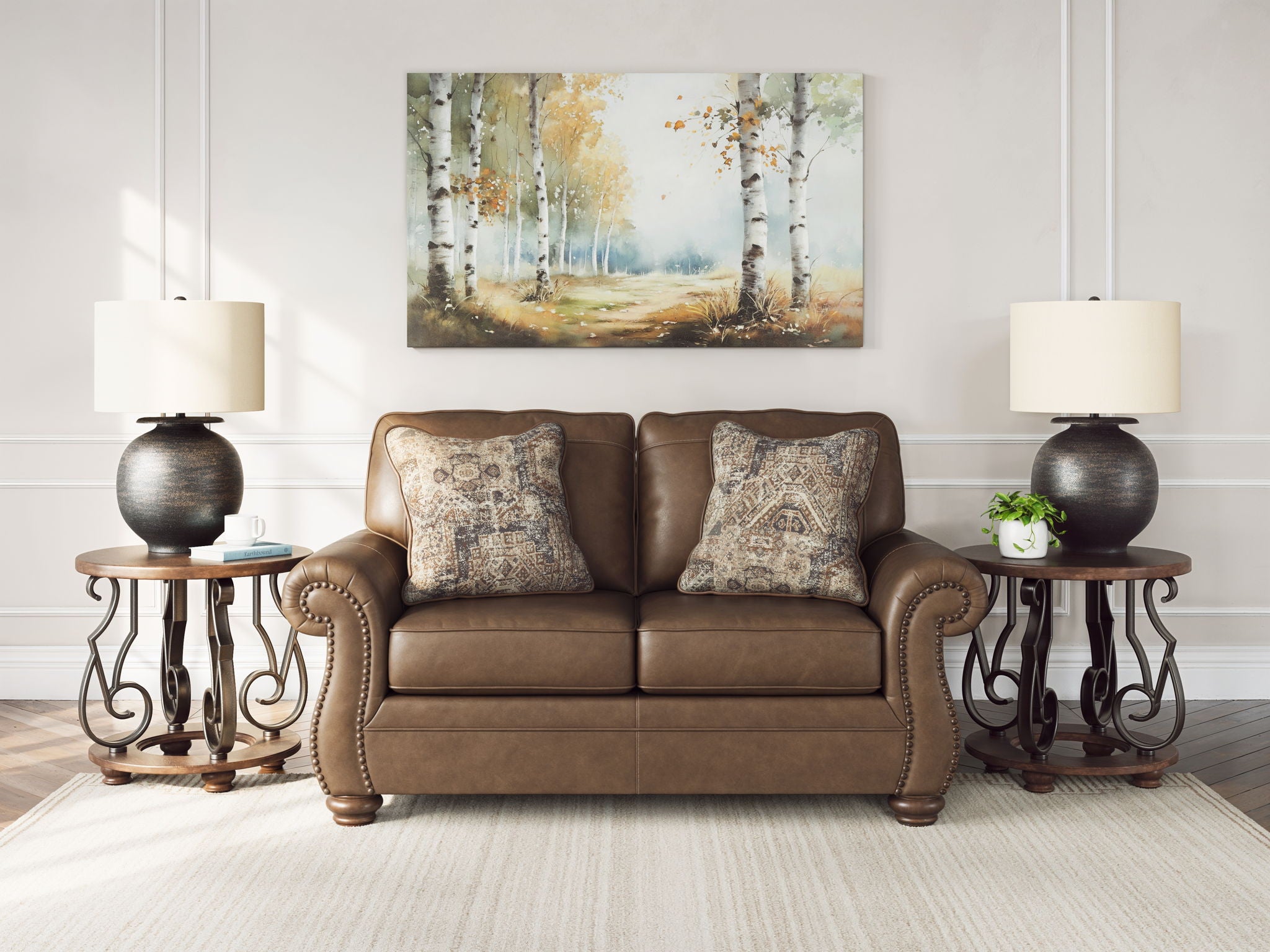 Brown loveseat with two patterned throw pillows and rolled arms