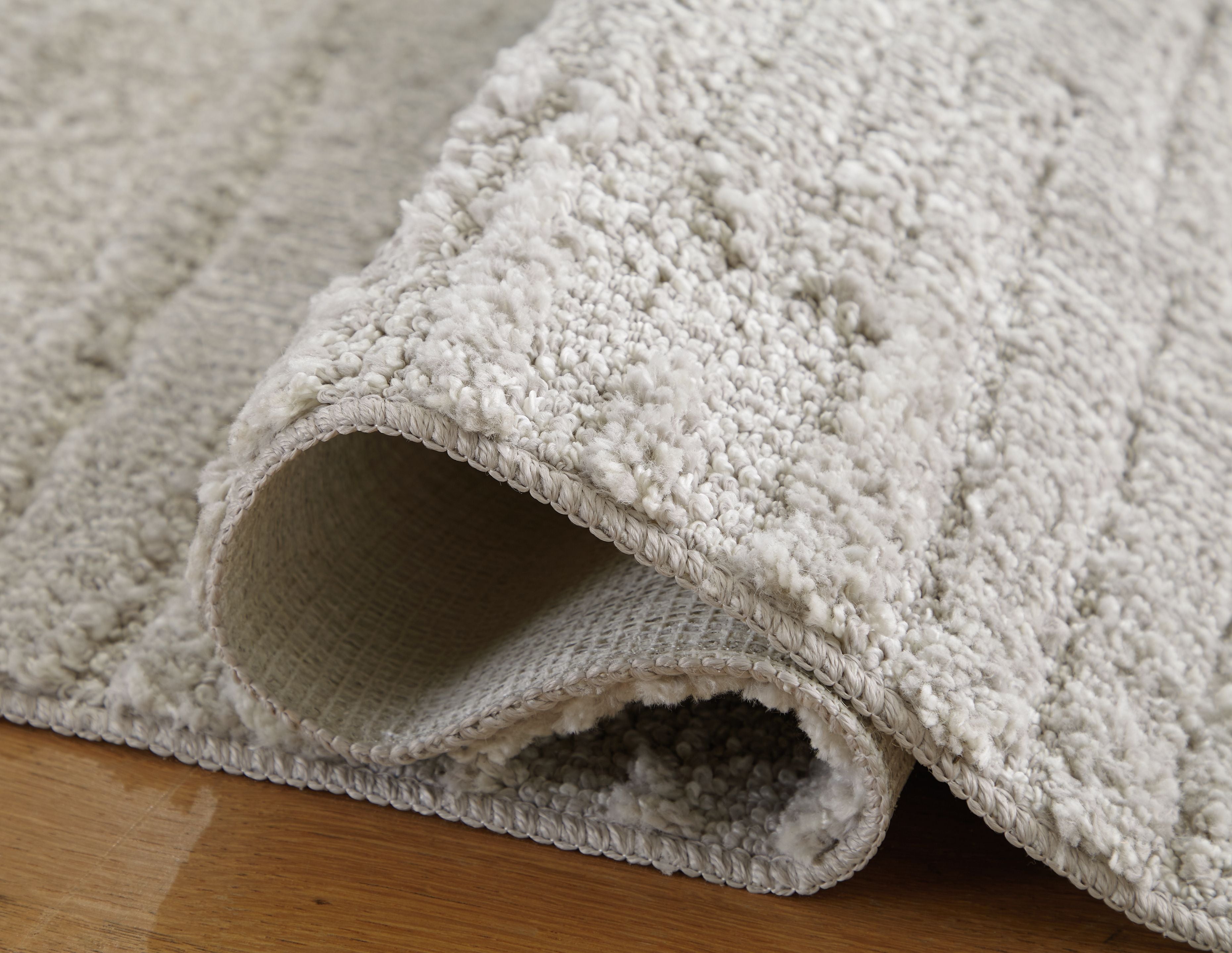 Ivygail Rug, light gray looped pile with turned-back edge showing backing