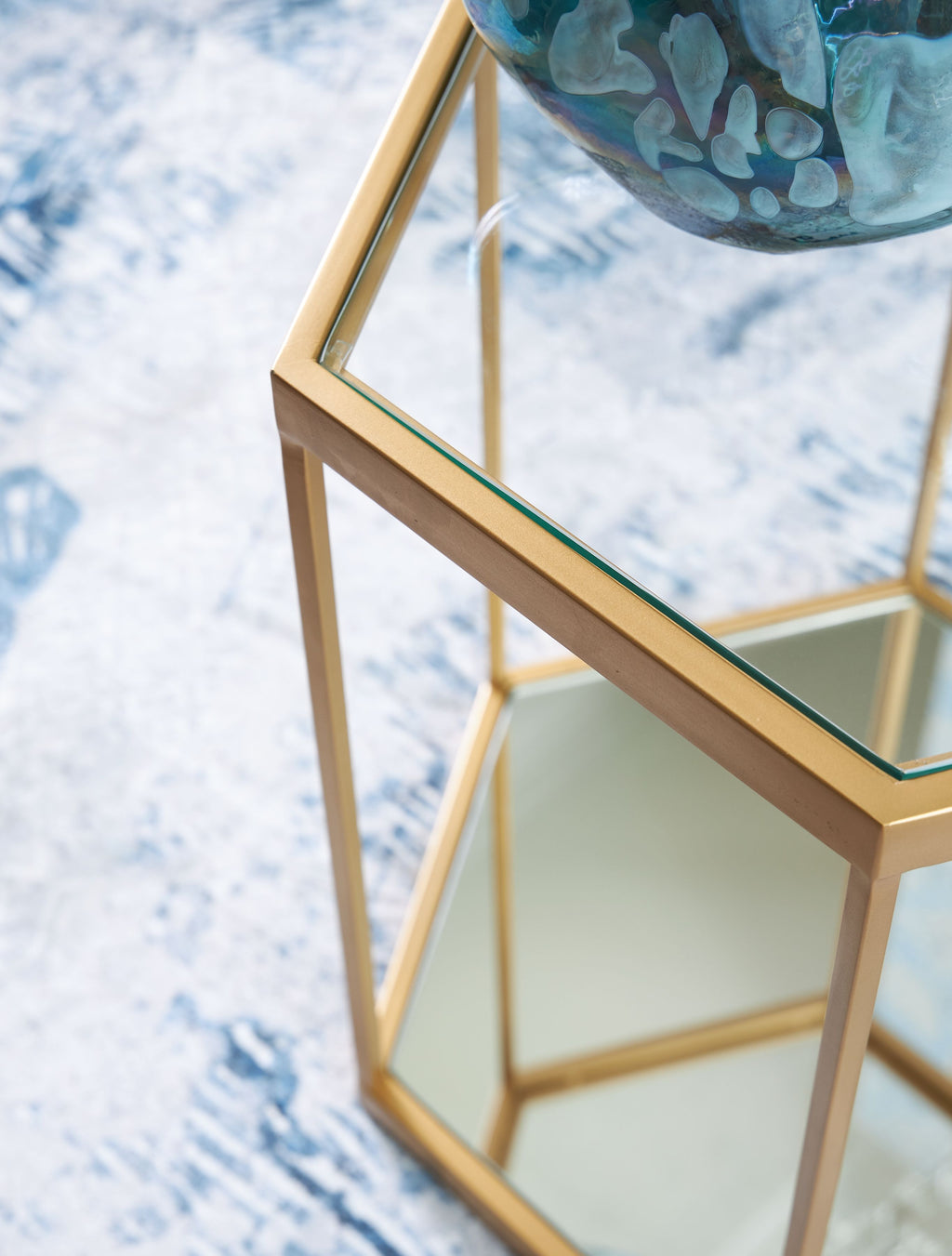 Gold-finish glass panel top and shelf on an octagonal side table