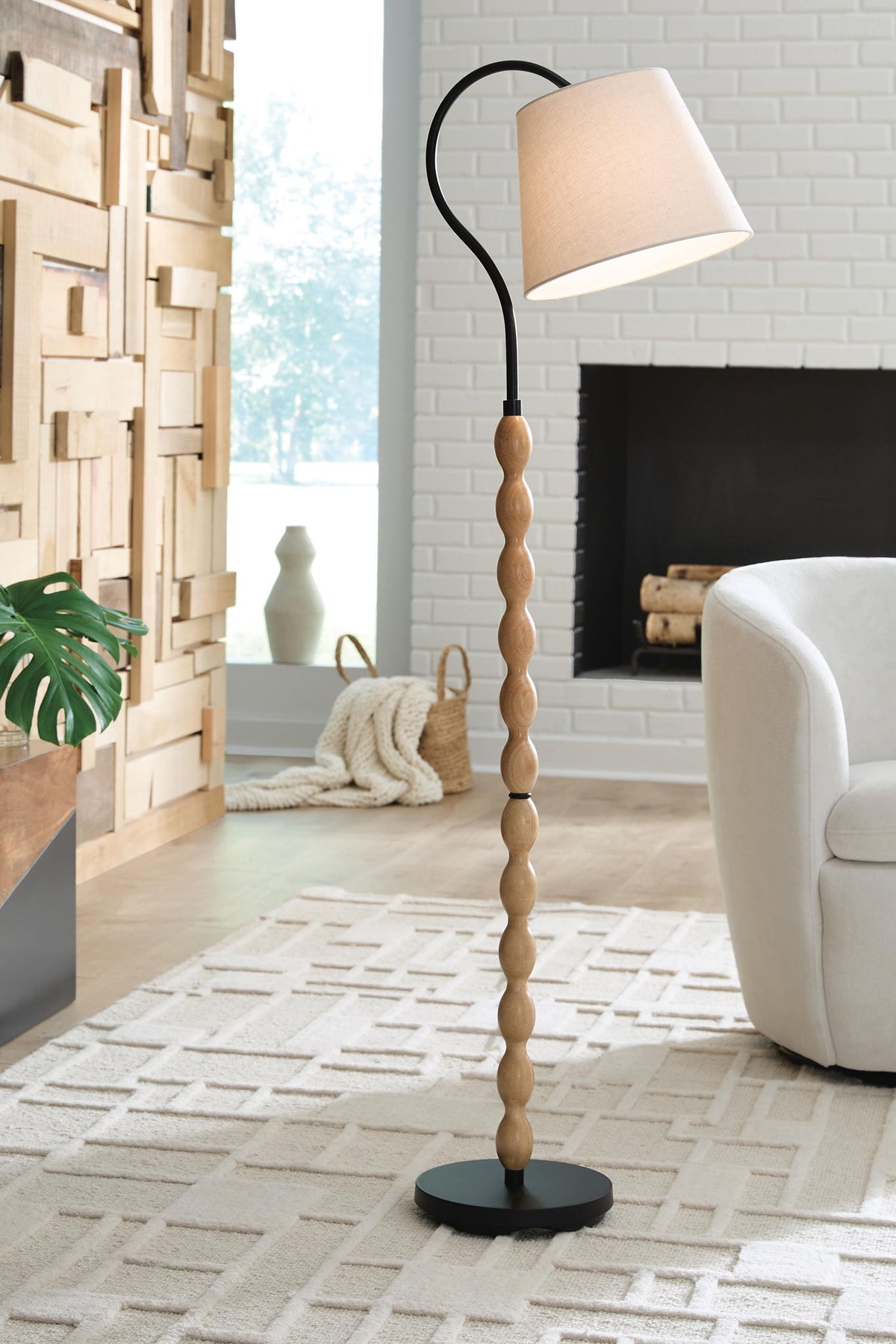 Tall floor lamp with beige square shade, turned wood column, and black round base