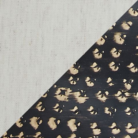 Close-up of black metal lamp base with gold studded pattern