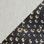 Close-up of black metal lamp base with gold studded pattern
