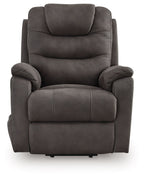 Gunmetal power lift recliner chair, gray fabric with rounded arms and segmented seat cushion.