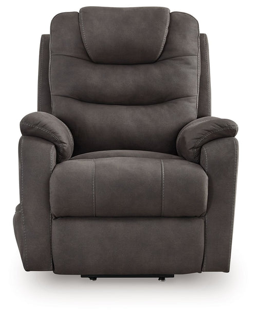 Gunmetal power lift recliner chair, gray fabric with rounded arms and segmented seat cushion.
