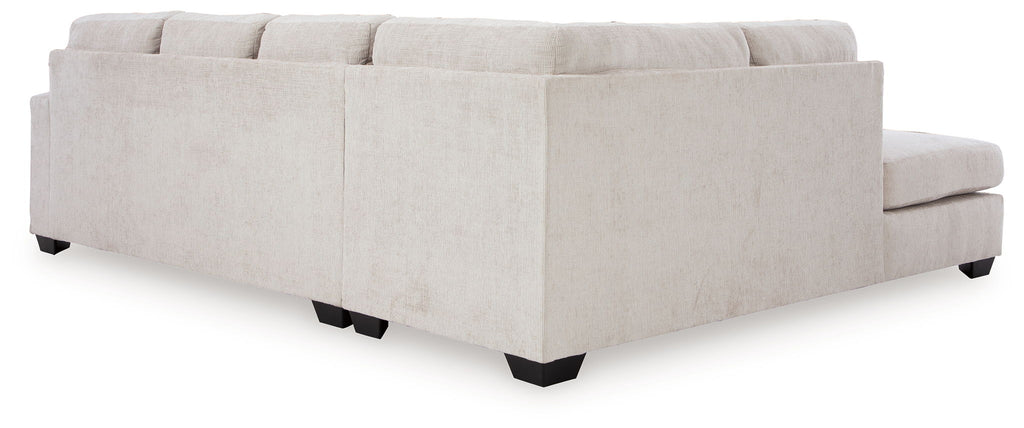 Light beige sectional sofa ottoman and chaise section with back cushions