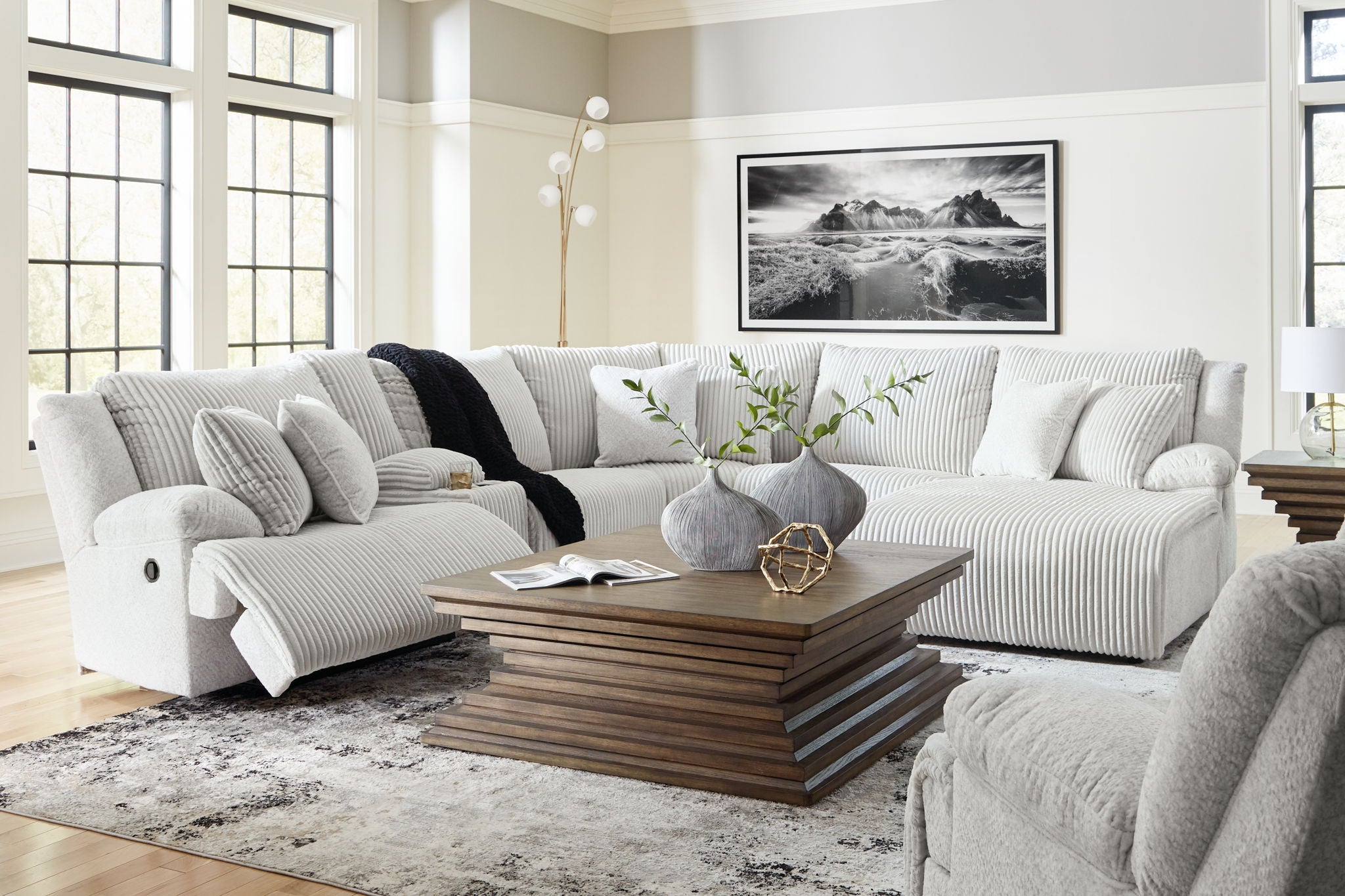 Light gray reclining sectional sofa with chaise and multiple back cushions
