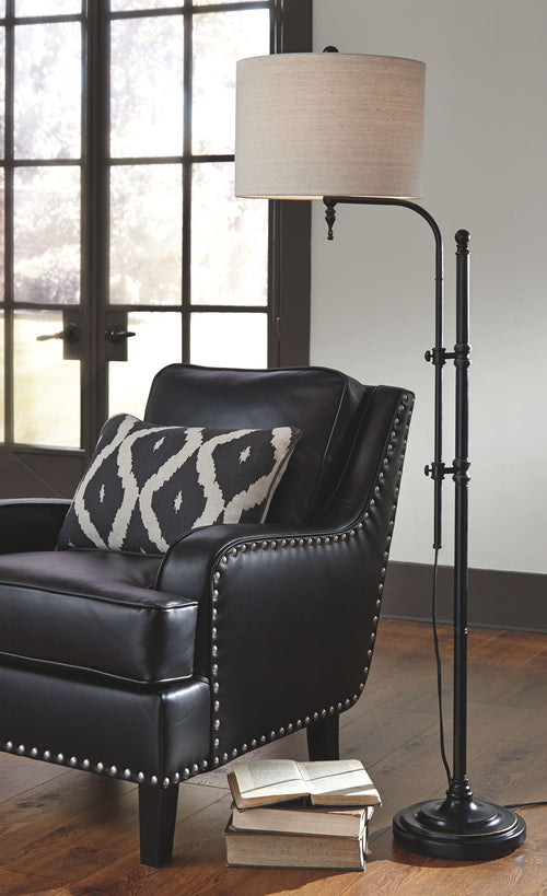 Black metal floor lamp with beige drum shade and arched base