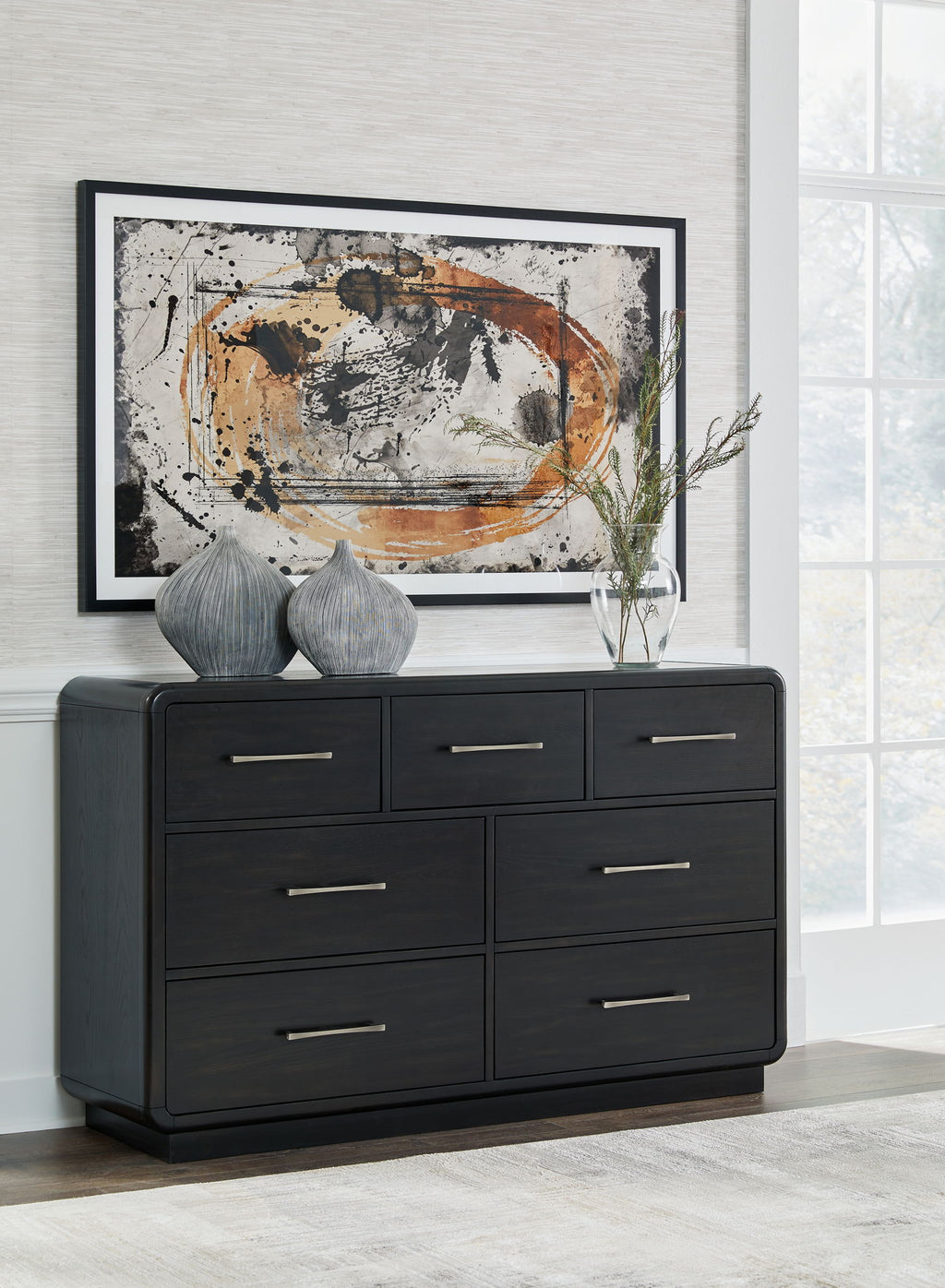 Black dresser with six drawers and metal bar pulls