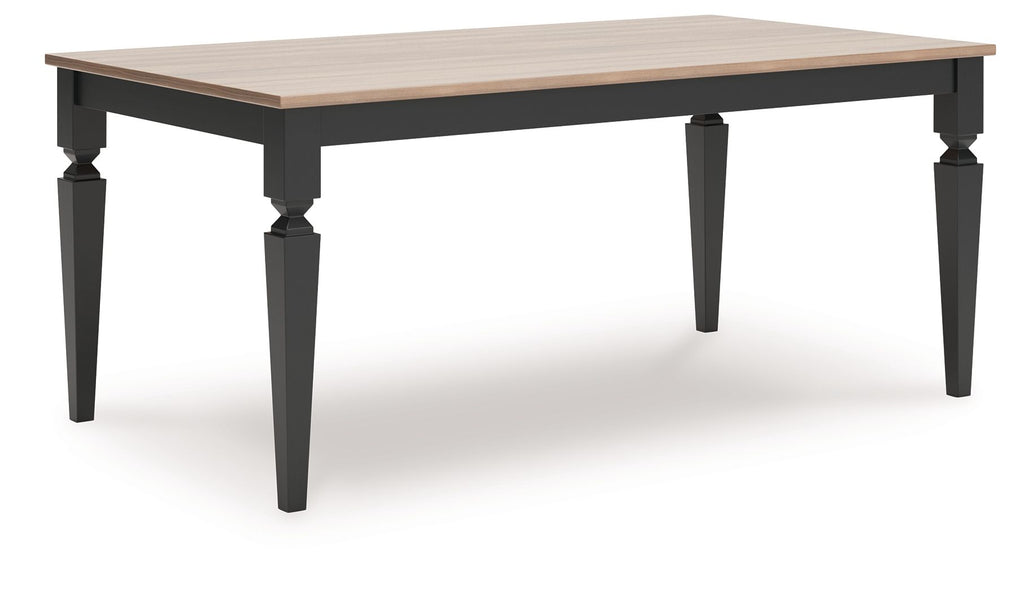 Rectangular dining room table with light wood top and dark turned legs