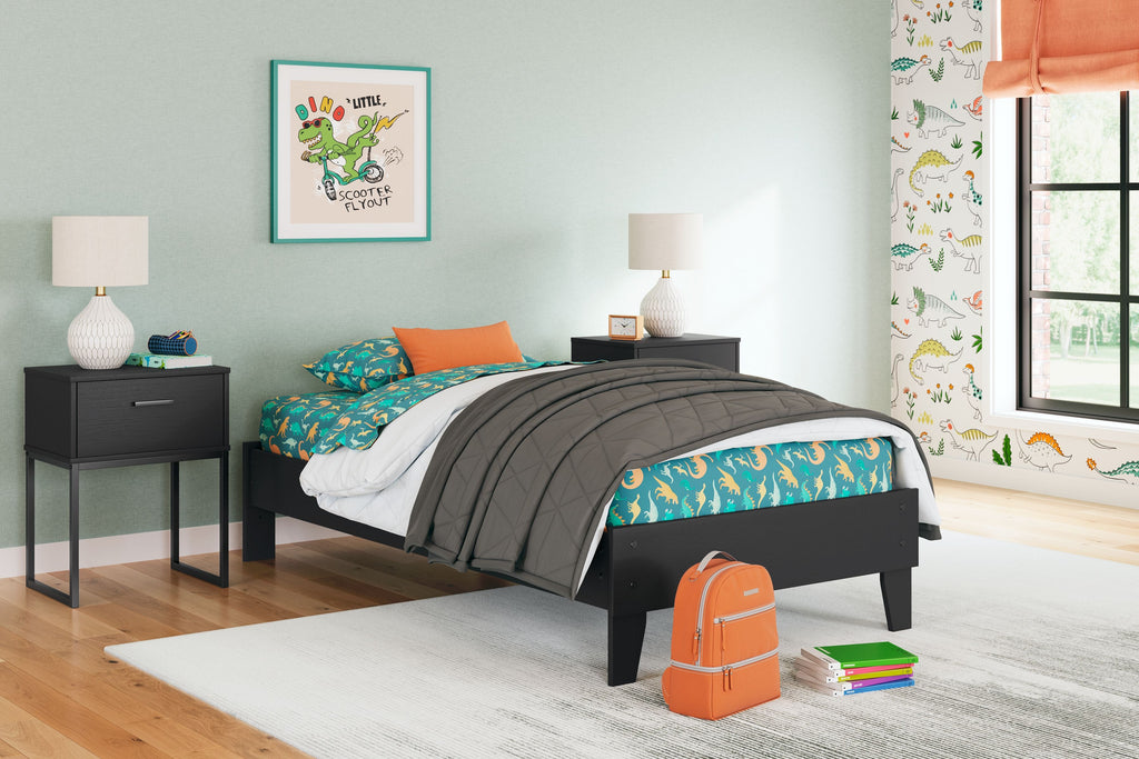Dark platform bed with mattress and folded comforter on top