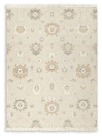 Beige rug with light ornate pattern and fringed edges, full view