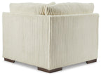 Ivory ribbed fabric wedge sectional chair with button-tufted back