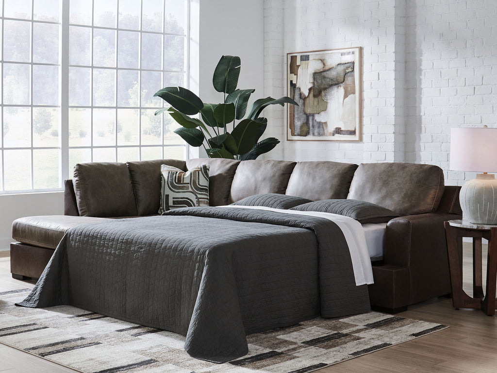 Dark fossil sectional sofa with chaise and gray pillows plus draped throw blanket