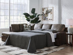 Dark fossil sectional sofa with chaise and gray pillows plus draped throw blanket