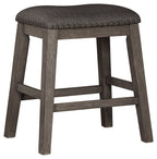 Dark gray upholstered backless padded stool with nailhead trim, wooden legs