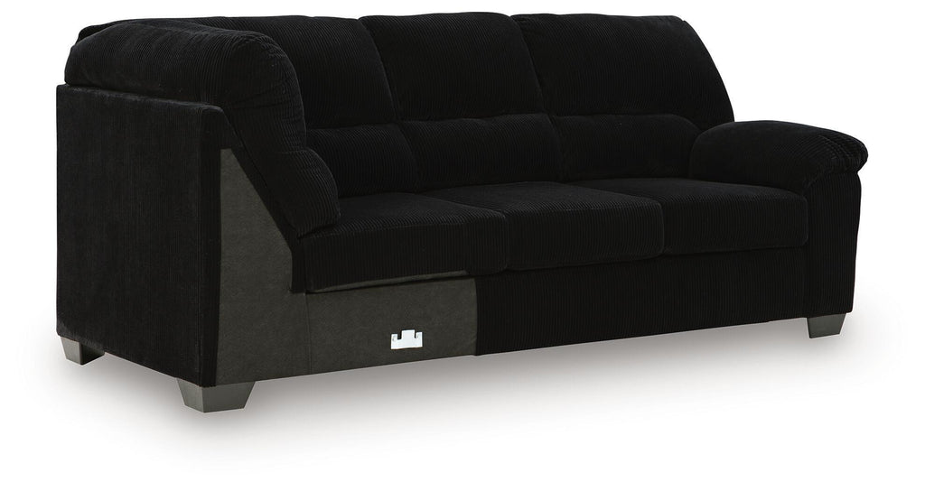 Dark fabric sofa with corner wedge, deep seat cushions and blocky legs