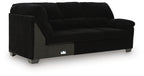 Dark fabric sofa with corner wedge, deep seat cushions and blocky legs