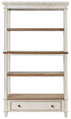 Brown and white wood bookcase with three open shelves and a lower drawer.