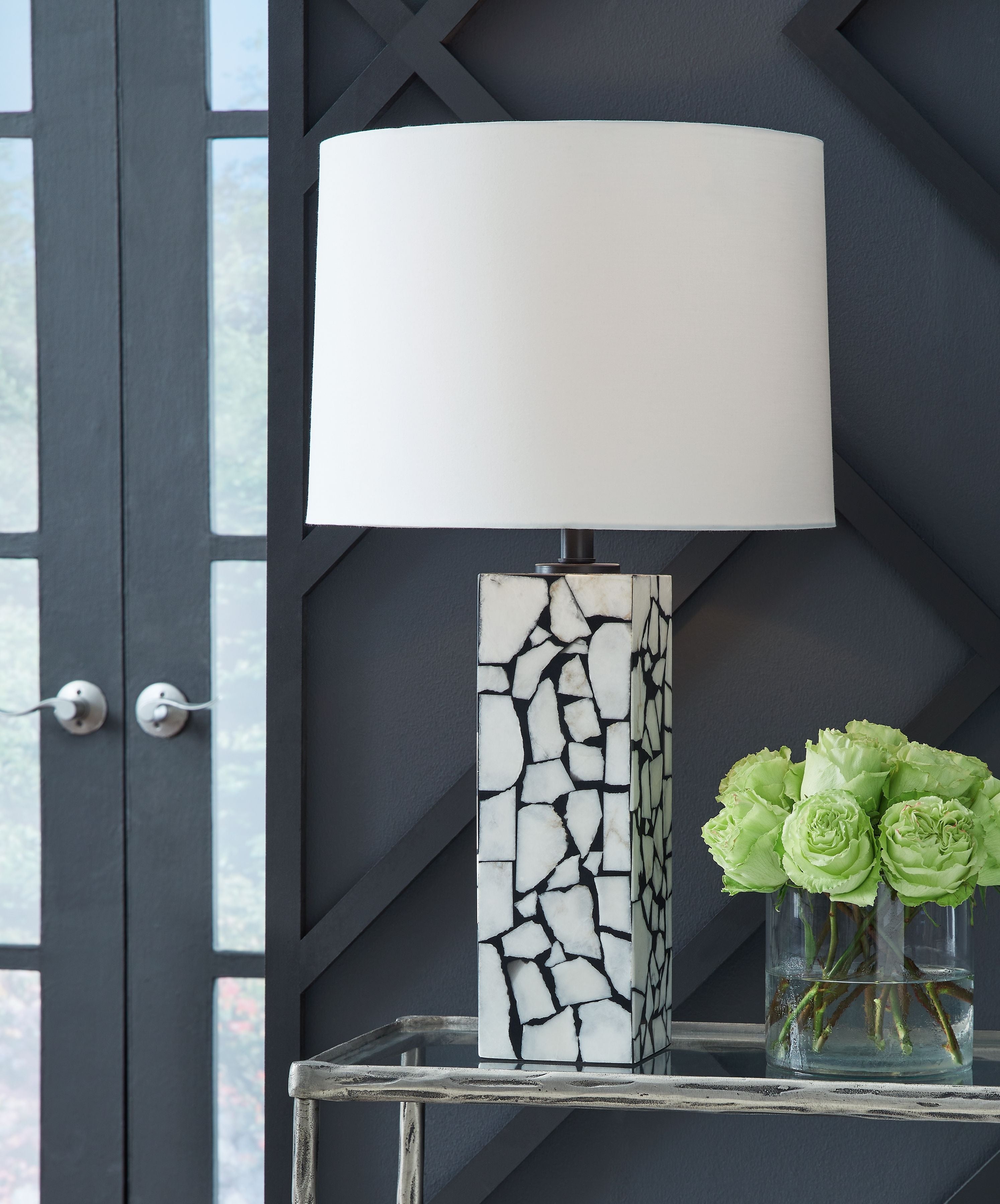 White fabric table lamp shade on marble mosaic column base, white and black