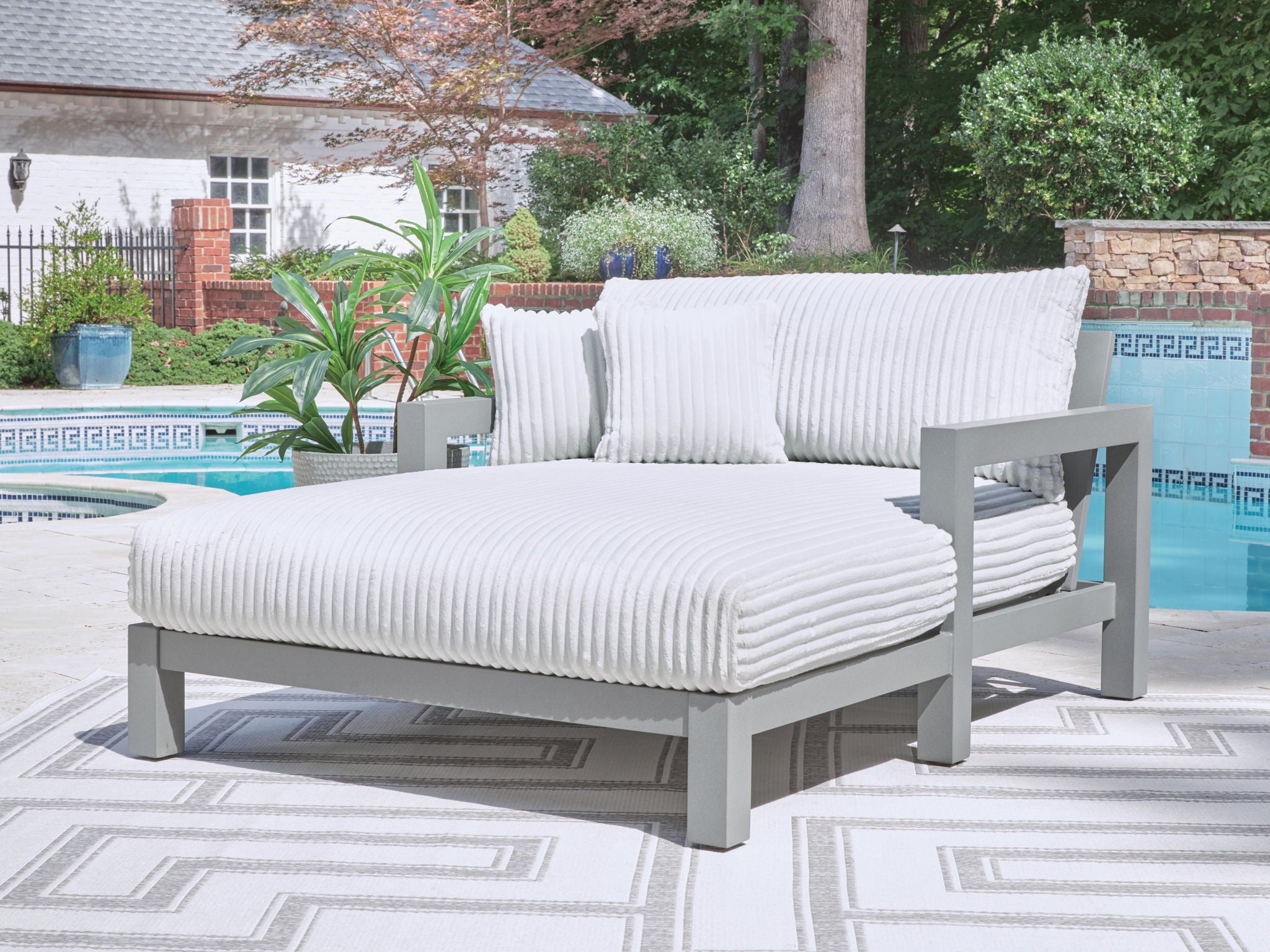 Chaise lounge with striped cushions and gray frame, light gray seat and back