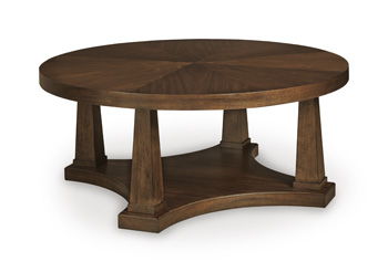 Round wooden table with dark brown top and carved pedestal base