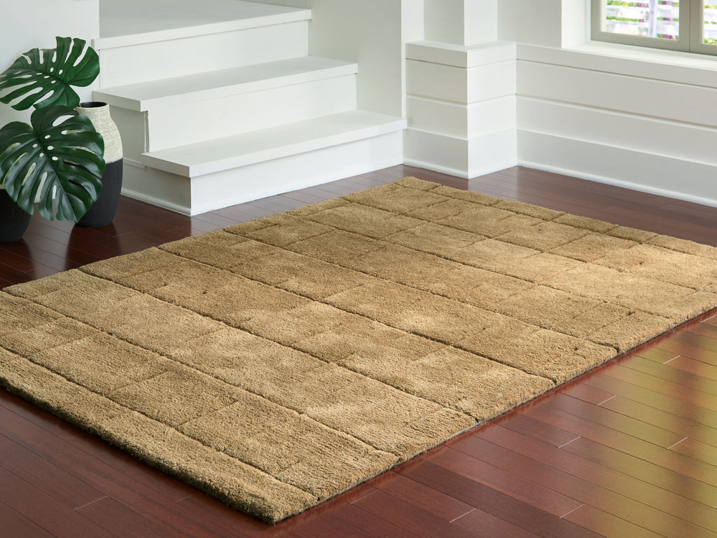 Light brown textured rug with rectangular block design and thin border
