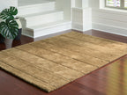 Light brown textured rug with rectangular block design and thin border