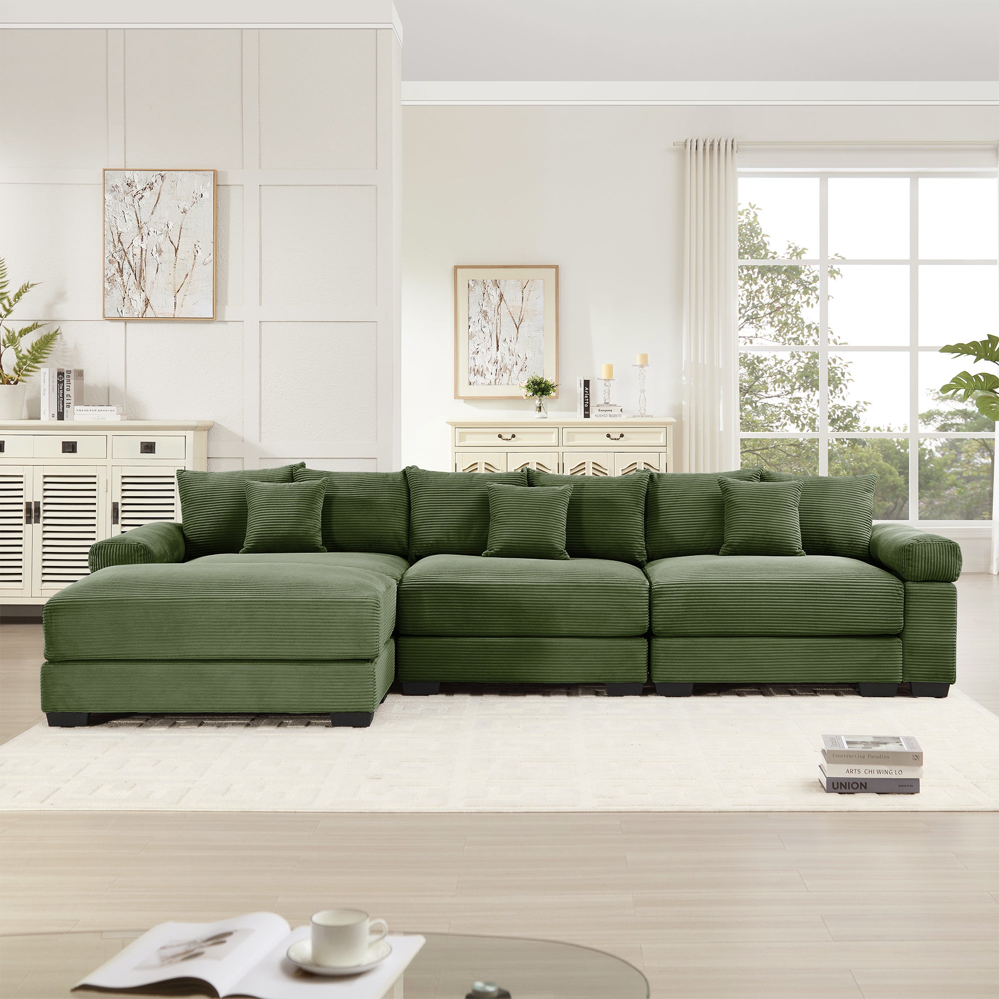 Green corduroy L-sectional sofa with modular ottoman and three seat cushions