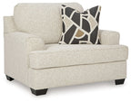 Beige upholstered loveseat with arms and dark geometric throw pillow
