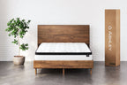 Ultra-plush hybrid mattress with white quilted cover and black edge trim, on frame