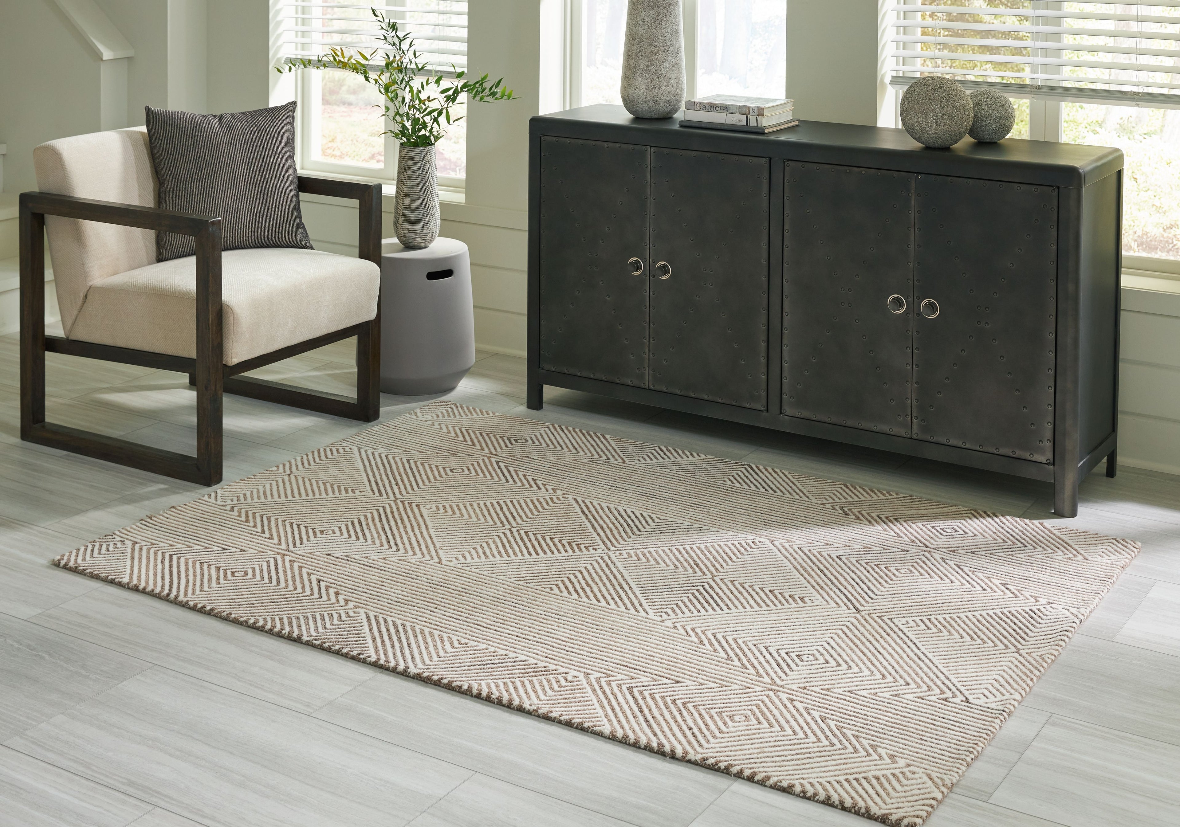 Beige geometric rug with repeating chevron and diamond design