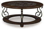 Dark brown round cocktail table, marble inset top, wrought-iron base with scroll accents
