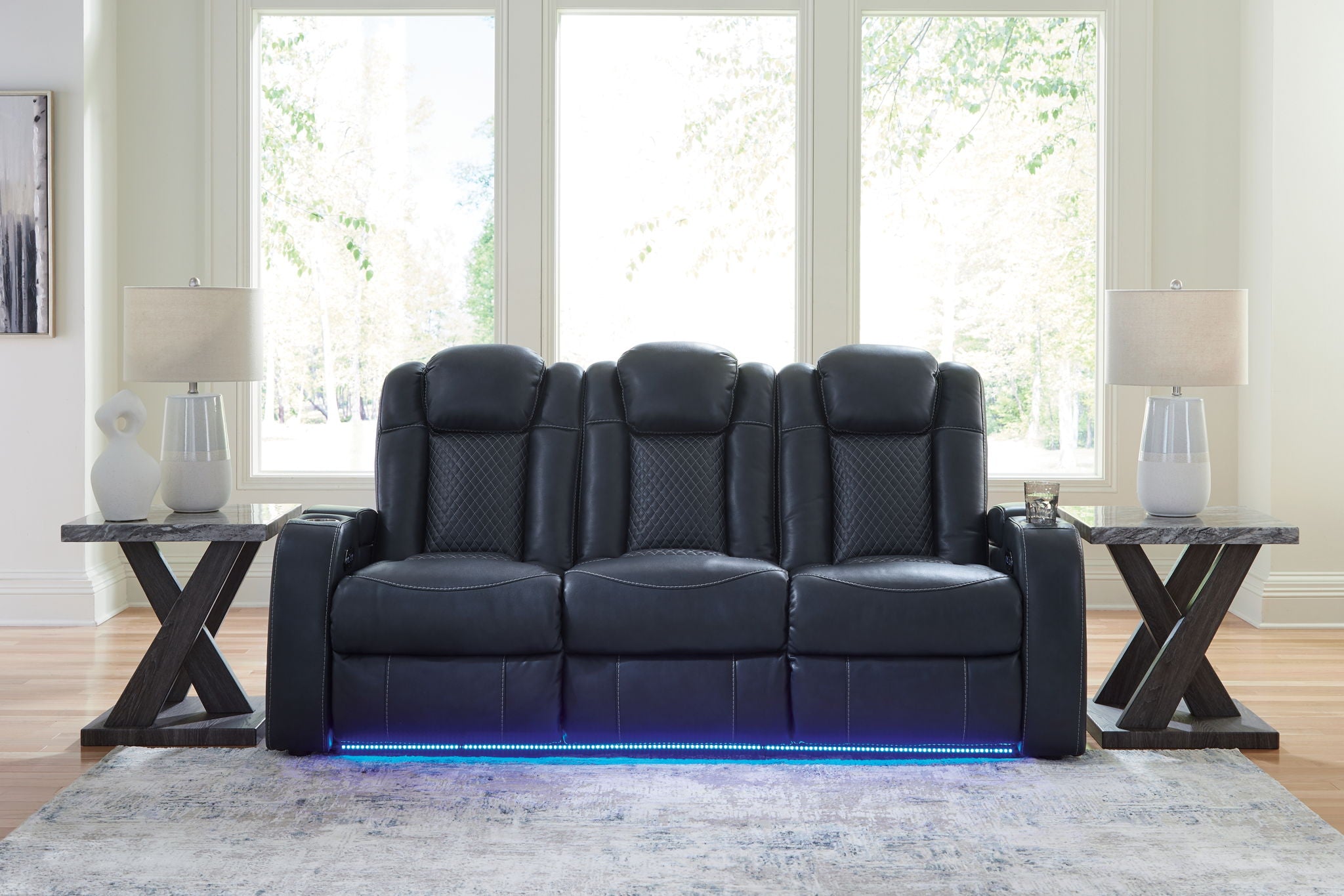 Dark gray reclining living room set loveseat with tufted back and blue-lit base