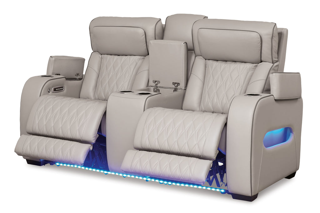 Gray power reclining loveseat with console, quilted seats, and blue-lit base