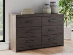 Charcoal six-drawer dresser front with four visible drawers and metal bar handles.