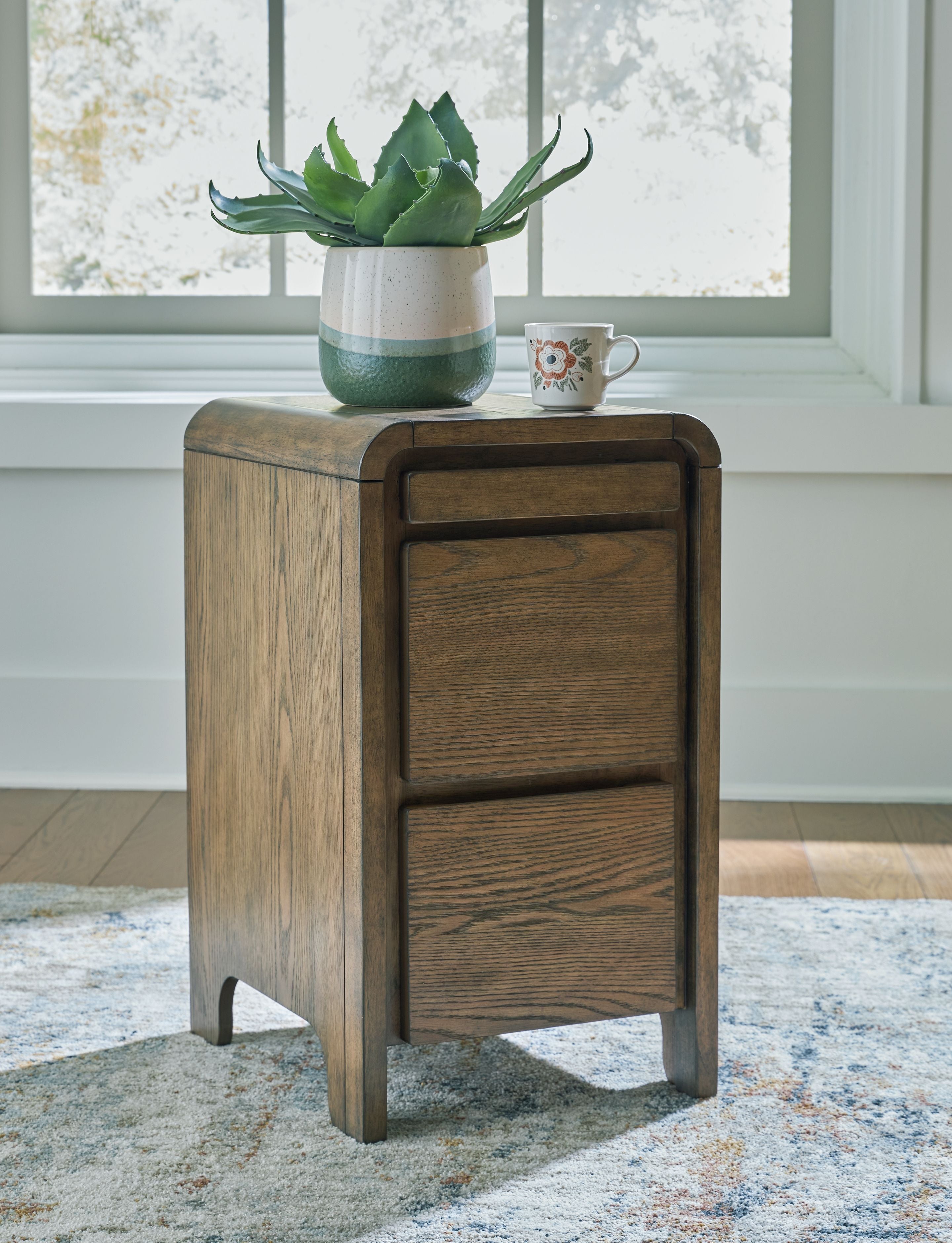 Brown wooden accent table with two-panel cabinet front and tapered legs