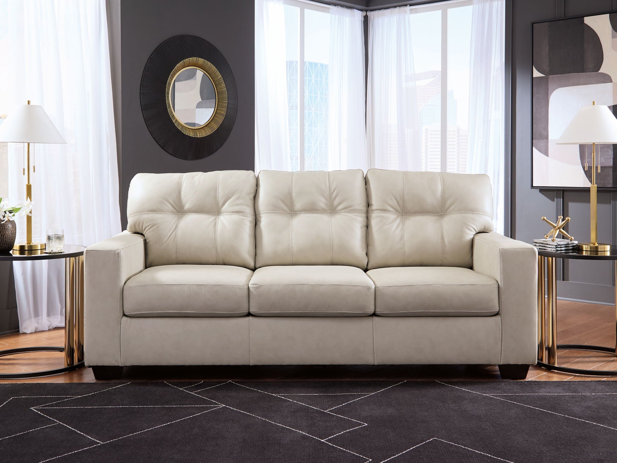 Beige sofa with tufted back and three padded seat cushions