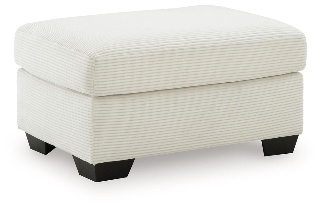 White upholstered ottoman with rounded lid, ribbed fabric texture and dark legs
