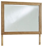 Rectangular bedroom mirror with brown wood frame and clear glass
