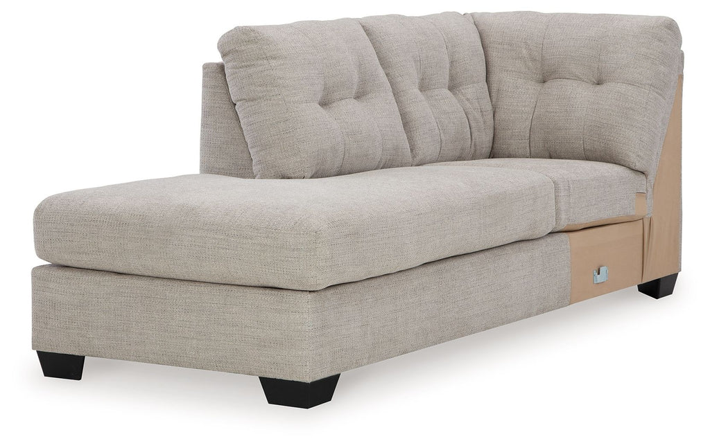 Corner chaise in light gray fabric with tufted back cushions and wide armrests