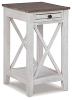 Accent table with open shelf, drawer, weathered white finish and dark gray top.