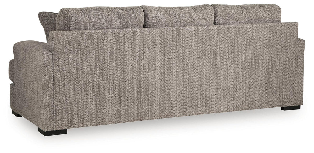 Gray fabric sofa with boxy back cushions and dark base legs